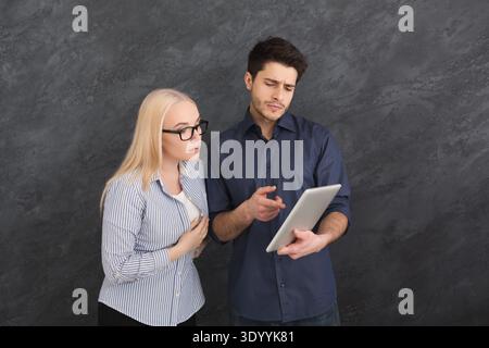 Serious couple using digital tablet at studio Stock Photo