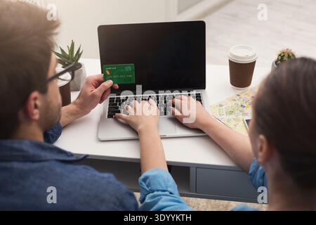 Couple planning trip, searching and paying online Stock Photo
