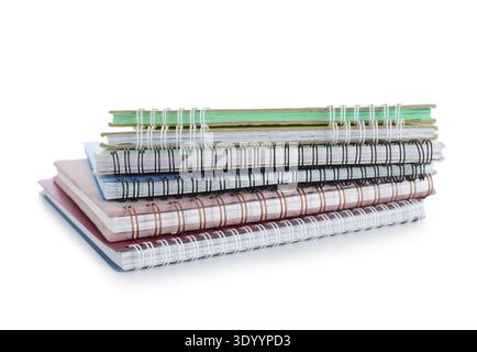 Stack of many different notebooks isolated on white background Stock Photo