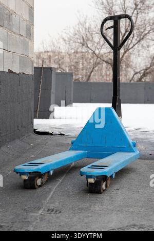 Blue pallet jack on a construction site rooftop Stock Photo