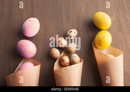 Easter composition with eggs in craft paper cornets Stock Photo