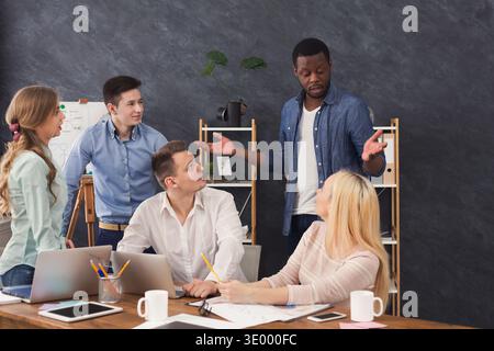 Company coworkers discussing ideas in office Stock Photo