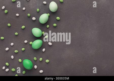 Easter background. Colored eggs and sweets on gray stone surface Stock Photo