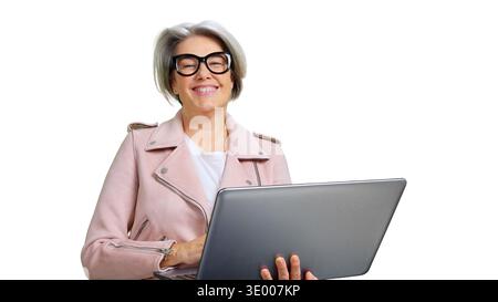 Senior woman smiling using laptop isolated on white Stock Photo