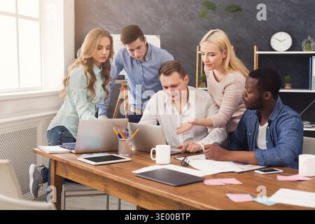 Company coworkers discussing ideas in office Stock Photo