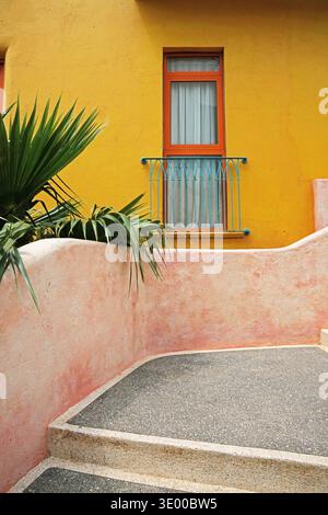One window and yellow wall and stone steps . Stone house. European Mediterranean architecture Stock Photo