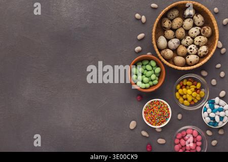 Easter eggs and sprinkles on gray slate background Stock Photo
