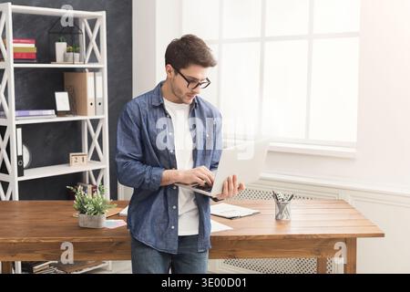 Young concentrated businessman using laptop Stock Photo