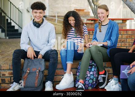 Education, laugh or friends in high school with break, bonding or shared opportunity in academic development. Happy, kids or students with recess Stock Photo