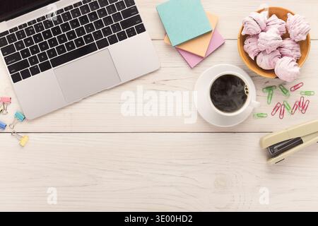 Desk with coffee cup and laptop, copy space Stock Photo