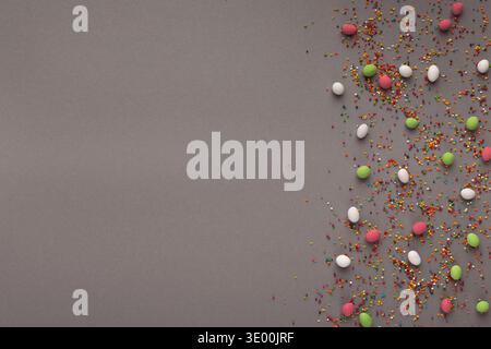 Various sweets and colorful sprinkles on gray table Stock Photo