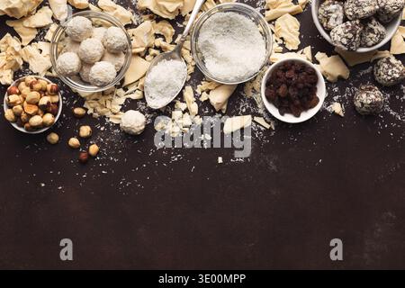 Crushed white chocolate pieces and truffles on dark background Stock Photo