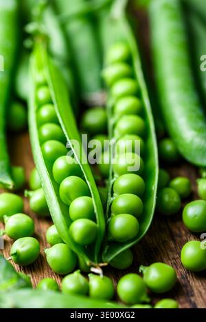Fresh green peas in pods forming natural food background. Organic vegetable ingredient Stock Photo