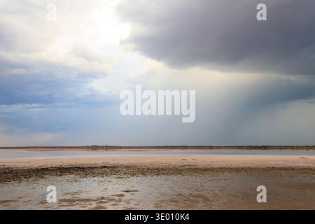 Dark storm clouds over a salt lake before a rain Stock Photo