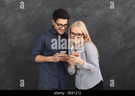 Couple shopping online with smartphone Stock Photo