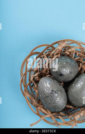Close up Easter eggs with silver texture in nest and ribbon Stock Photo