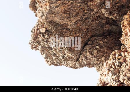 Natural rocky cliff texture with brown stones and rough geological surface pattern Stock Photo