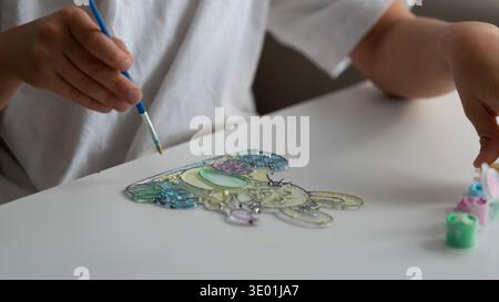 Child Painting Easter Bunny Craft with Brush Close Up Stock Photo