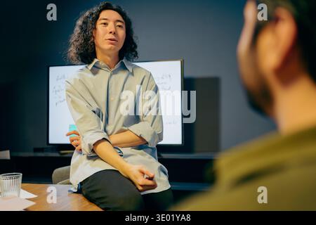 focused discussion around strategy, individuals deeply analyzing ideas during collaborative meeting Stock Photo