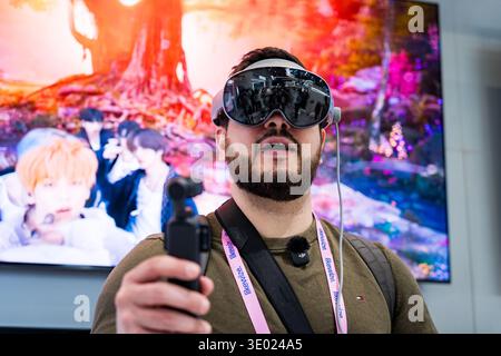 Barcelona, Spain - 02.03.2026: a man is seen trying augmented reality or virtual reality headset at mobile world congress Stock Photo