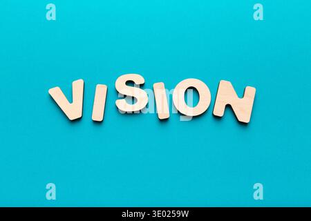 Wooden letters spelling Vision on blue background Stock Photo