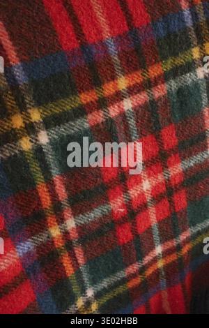 Full frame texture of a traditional Scottish tartan plaid fabric, featuring vibrant red, green, blue, yellow, and white colors Stock Photo