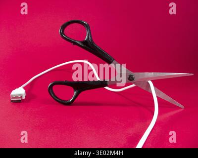 Cutting wire with scissors - tech, internet, information and communication styled concept, elegant visuals Stock Photo