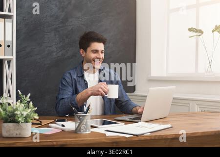 Young happy businessman working with laptop Stock Photo