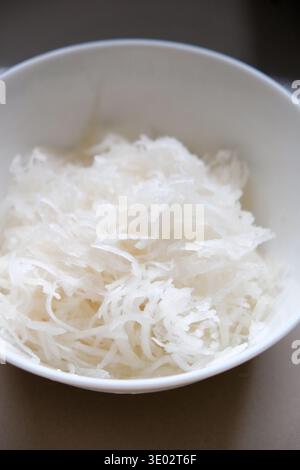 Freshly sliced red radishes in a ceramic bowl Stock Photo