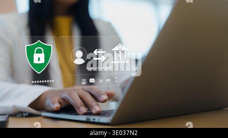 Businesswoman using laptop for secure online payment with shield icon and successful transaction message. Concept of cyber security, digital banking s Stock Photo
