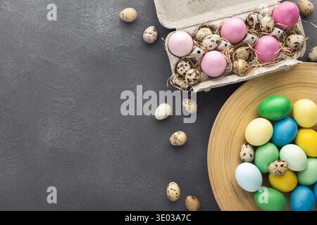 Colored Easter and quail eggs set on black table Stock Photo