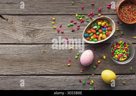Easter eggs and colorful candies with copy space Stock Photo