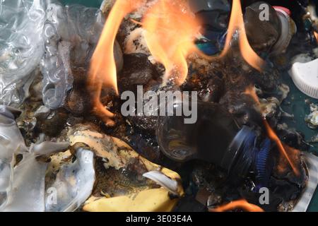 top view view a group of bottles and plastic containers that are burning Stock Photo