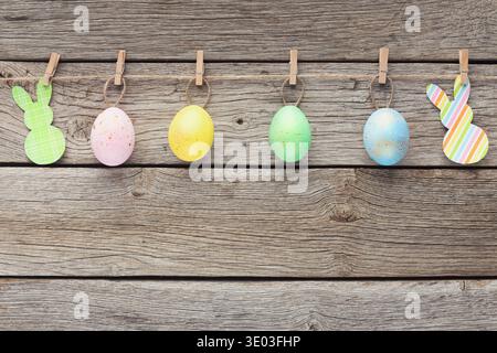 Colourful eggs and raper rabbits on rope Stock Photo