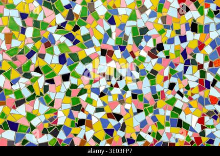 Colorful mosaic tile pattern with irregular ceramic pieces, vibrant abstract geometric background texture, decorative wall Stock Photo