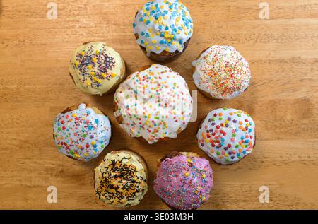 Homemade Easter pastries decorated with traditional colorful confectionery sprinkles stand on the table. Top view. Ukrainian traditions of preparing f Stock Photo