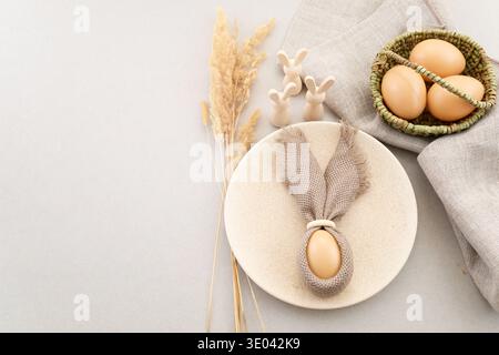 Zero waste Easter. Rustic easter table setting with bunny ear napkin Stock Photo