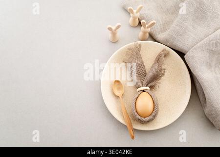 Zero waste Easter. Easter table setting with egg bunny and wooden rabbits Stock Photo