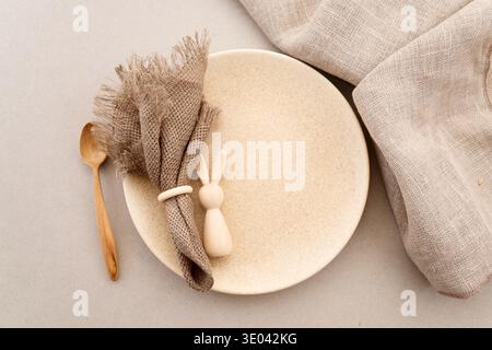 Zero waste Easter. Easter table setting with wooden bunny and linen napkin Stock Photo