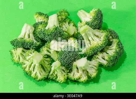 Green broccoli cabbage isolated on a green background. Stock Photo