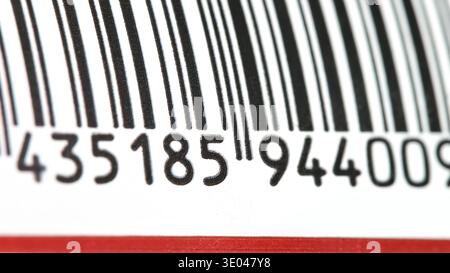 Barcode on generic product label macro extreme closeup, black stripes and numbers with shallow depth of field, retail packaging identification code sc Stock Photo