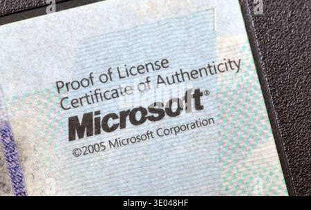 Microsoft certificate of authenticity proof of license sticker, extreme closeup macro detail of 2005 COA label on computer hardware, retro software li Stock Photo