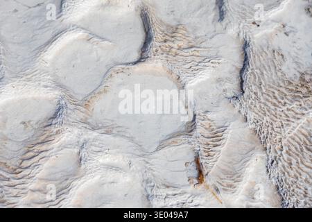 Close-up image of travertine showcasing its natural, textured surface. The intricate patterns and subtle color variations highlight the beauty of this Stock Photo