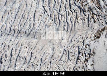 Close-up image showcasing the intricate textures and patterns of natural travertine rock. The unique formations highlight the geological beauty and co Stock Photo
