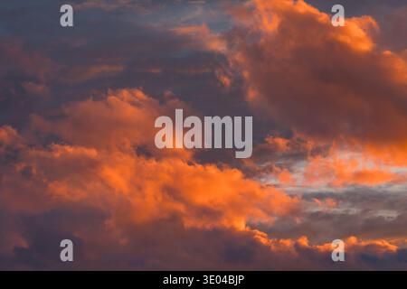 Abstract capture of a stunning sunset sky, with pink and orange clouds, offering a dramatic and moody atmosphere, hinting at an approaching rain showe Stock Photo