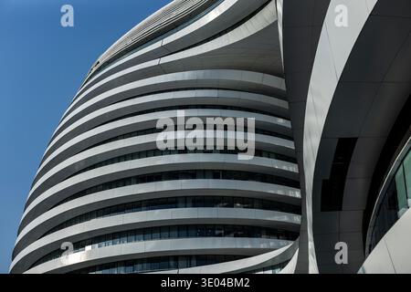 A close-up view of the innovative and futuristic Galaxy Soho complex in Beijing, showcasing its curvilinear architectural design and sleek white exter Stock Photo