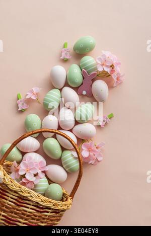 Easter Basket with Pastel Eggs, Flowers and Bunny Decorations. Festive Spring Flatlay Stock Photo