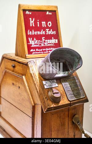 Close-up of a vintage wooden coin-operated motion picture viewer, likely a mutoscope or early kinetoscope, displayed in Frankfurt, Germany. The... Stock Photo