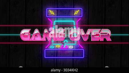Displaying neon arcade cabinet glowing on dark wood wall, with GAME OVER sign, joystick, buttons Stock Photo