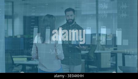 Discussing data, two colleagues in business-casual in open office viewing tablet with data overlay Stock Photo